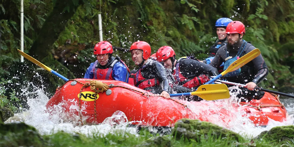 Group white water rafting in North Wales